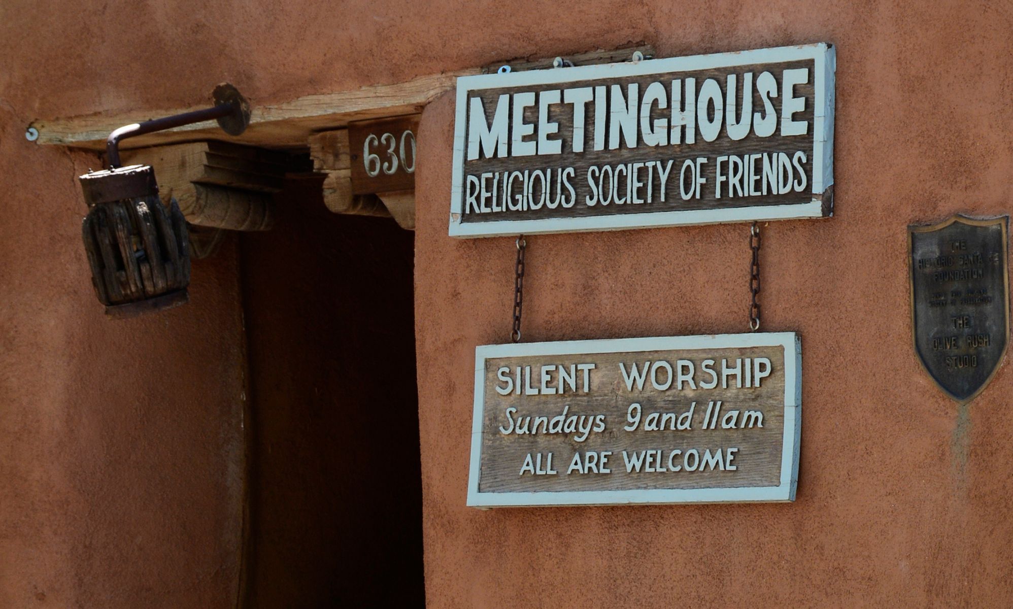 A Quakers sign reading &quot;Meeting House Religious Society of Friends. Silent Worship, Sundays 9 and 11am, ALL ARE WELCOME.&quot;