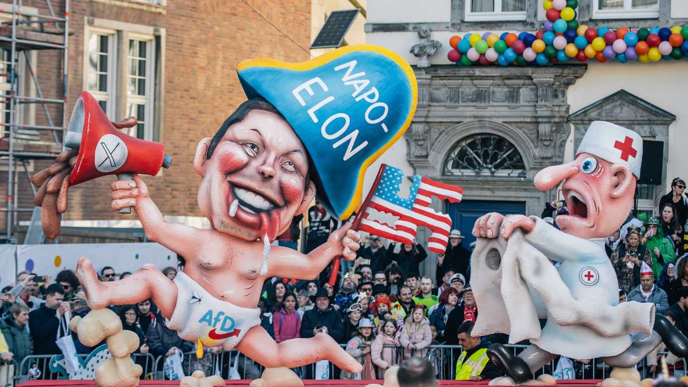 Diaper-clad Elon Musk depicted holding swastika and poo-filled megaphone at German parade