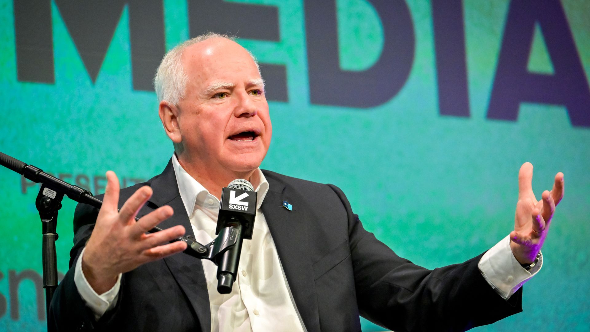 Tim Walz says he looks at Tesla's share price plunging to give him a boost through the day