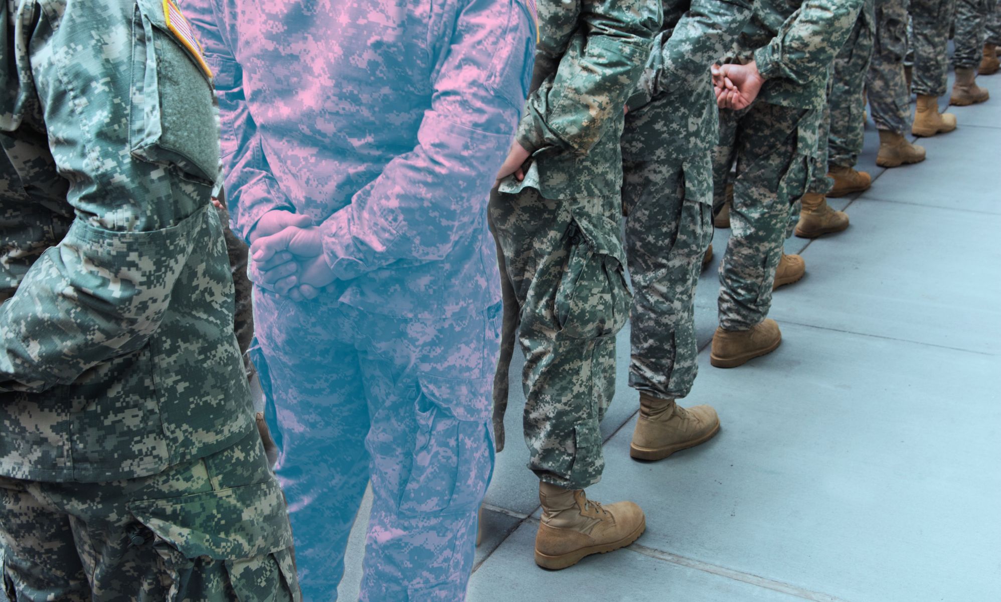 A military line-up, with one soldier in the trans colours.