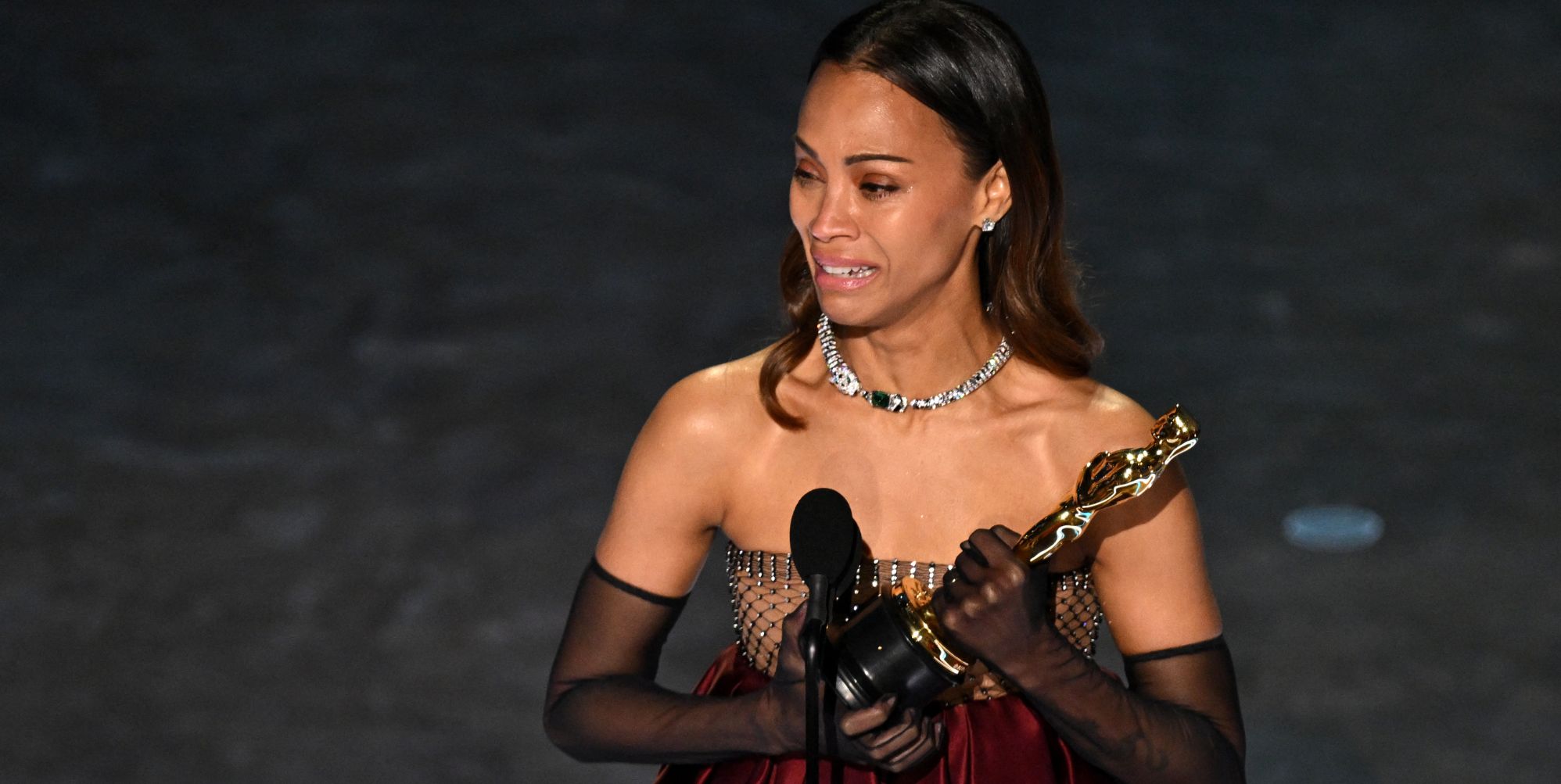 Zoë Saldaña breaks down in tears accepting Oscar for role in transgender crime musical Emilia Pérez