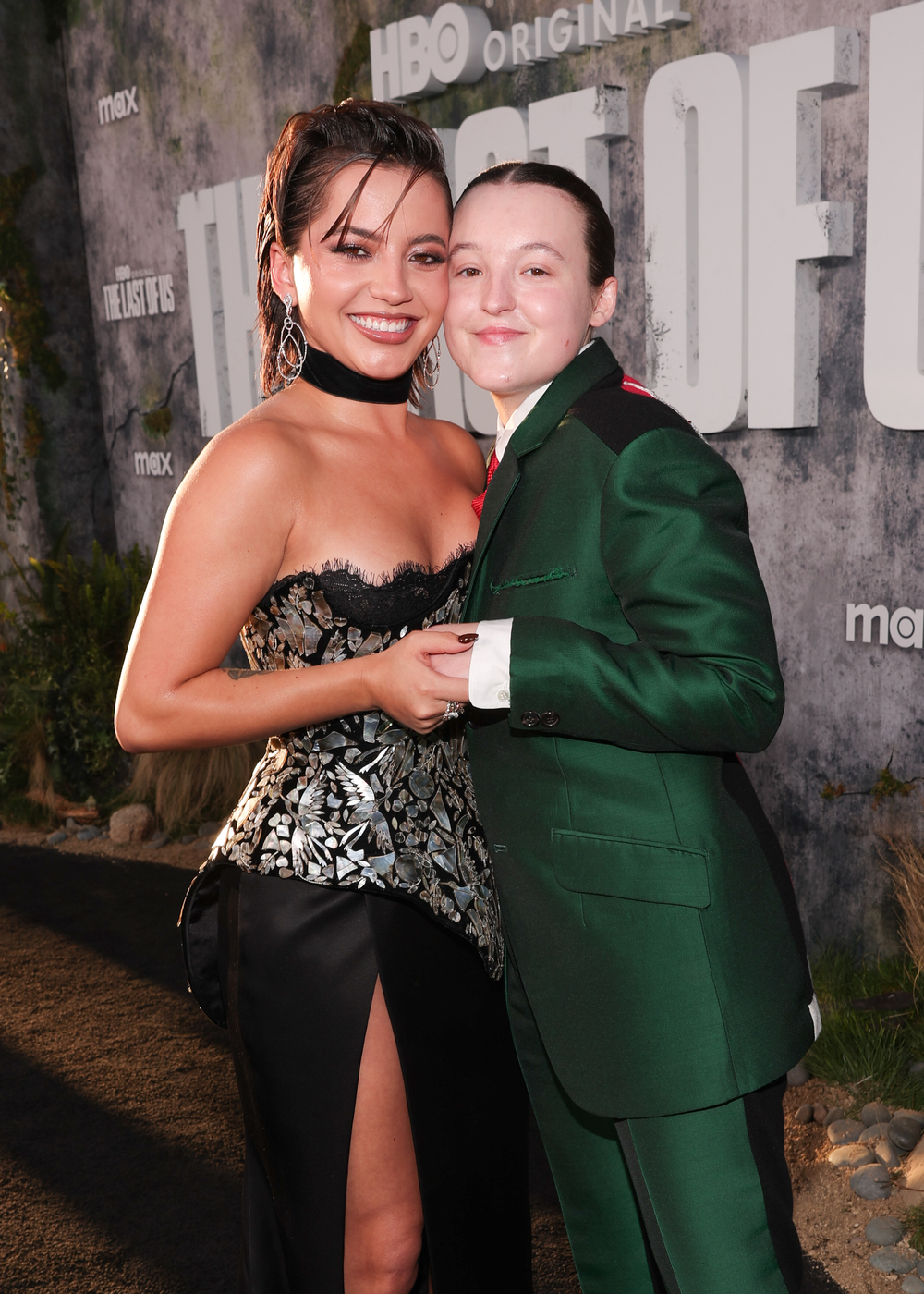 The Last of Us stars Isabela Merced and Bella Ramsey hug at the The Last of Us premiere.