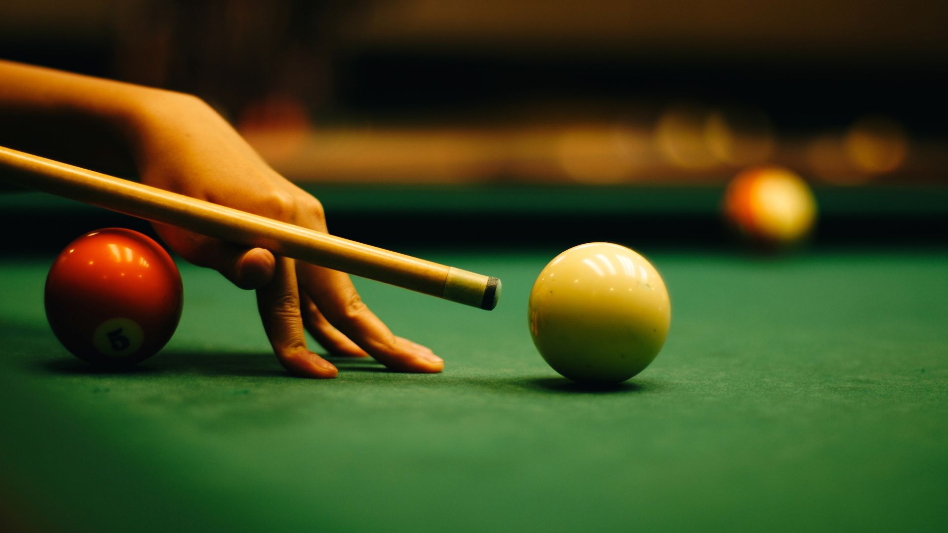 Stock image of a woman playing pool