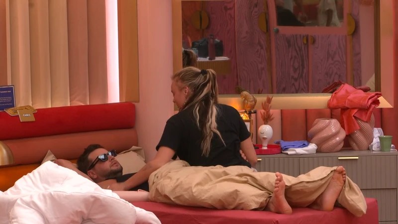 JoJo Siwa pictured sitting on a bed with Chris Hughes