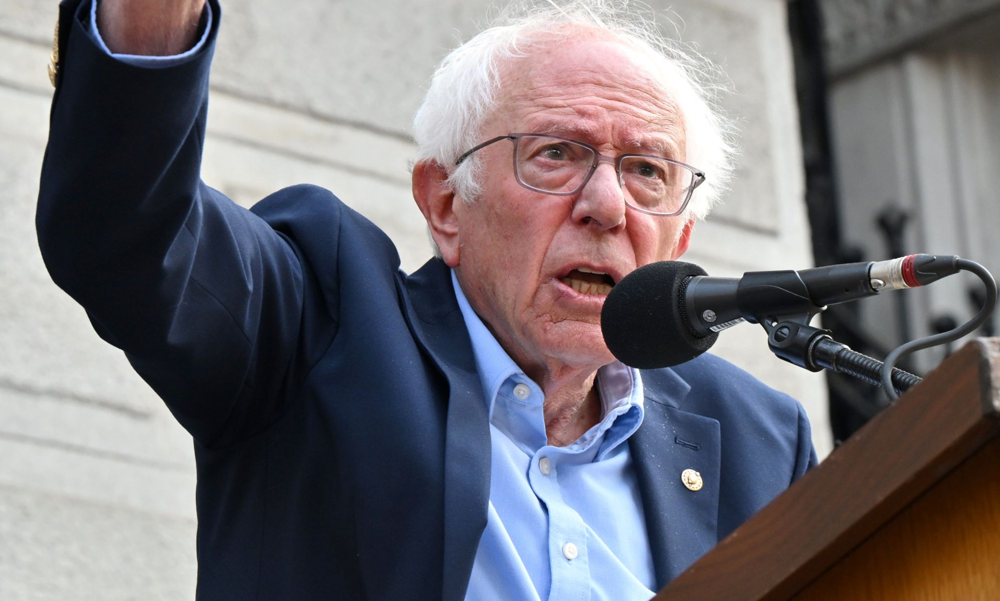 Bernie Sanders, pictured speaking into a microphone.
