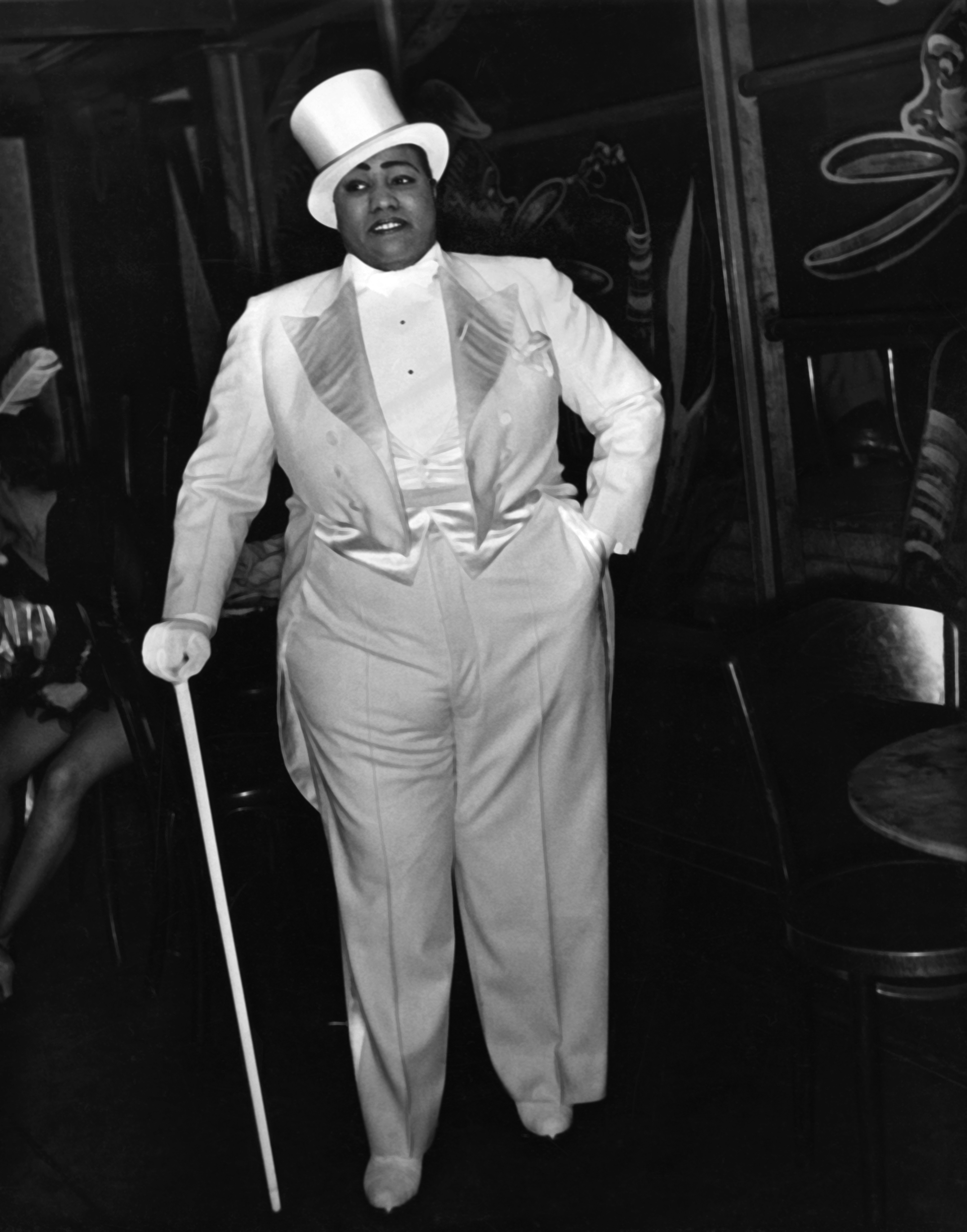 Black and white image of Gladys Bentley in a top hat, suit and cane