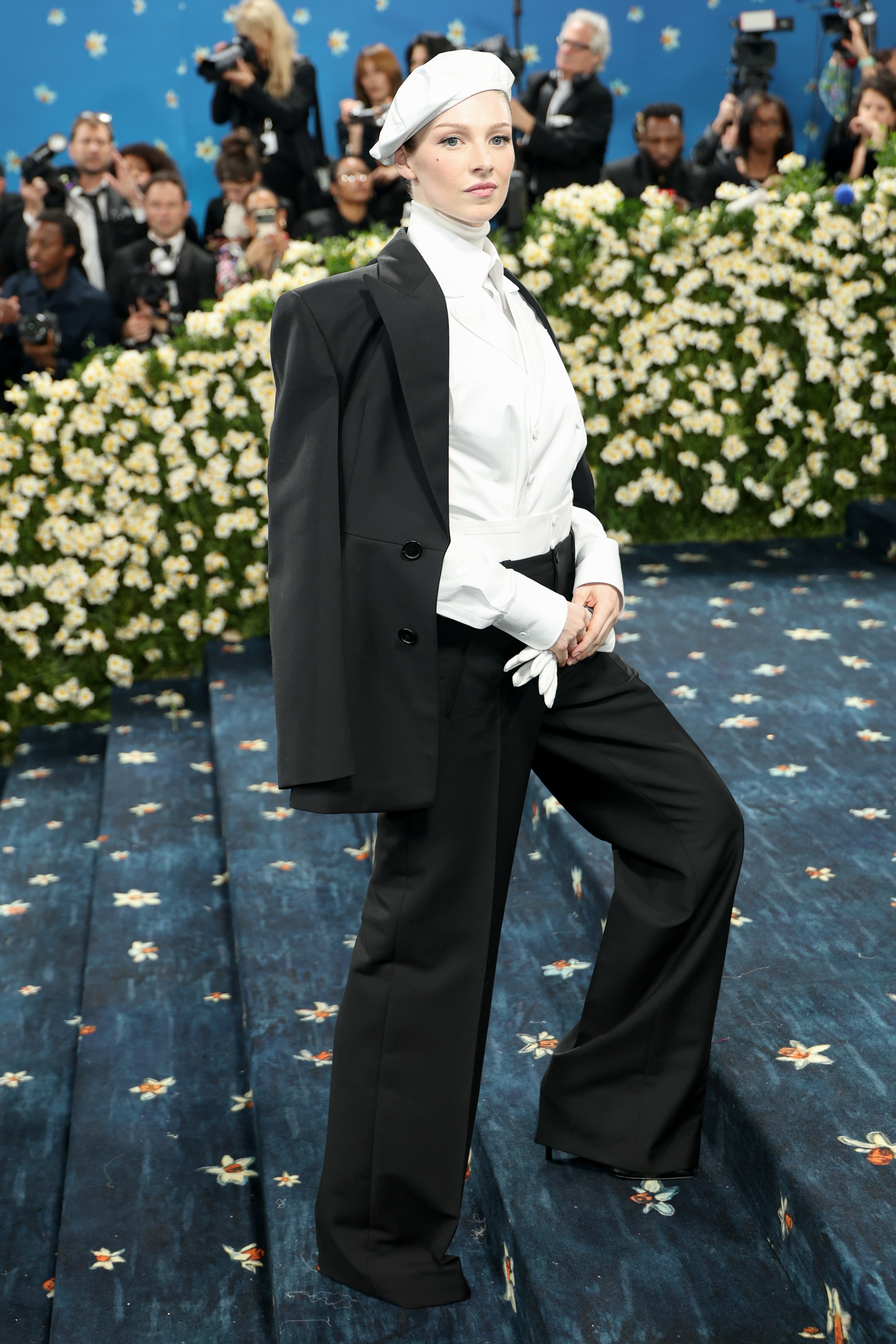 Hunter Schafer at the 2025 Met Gala, wearing a custom Prada black-and-white, multilayered suit.