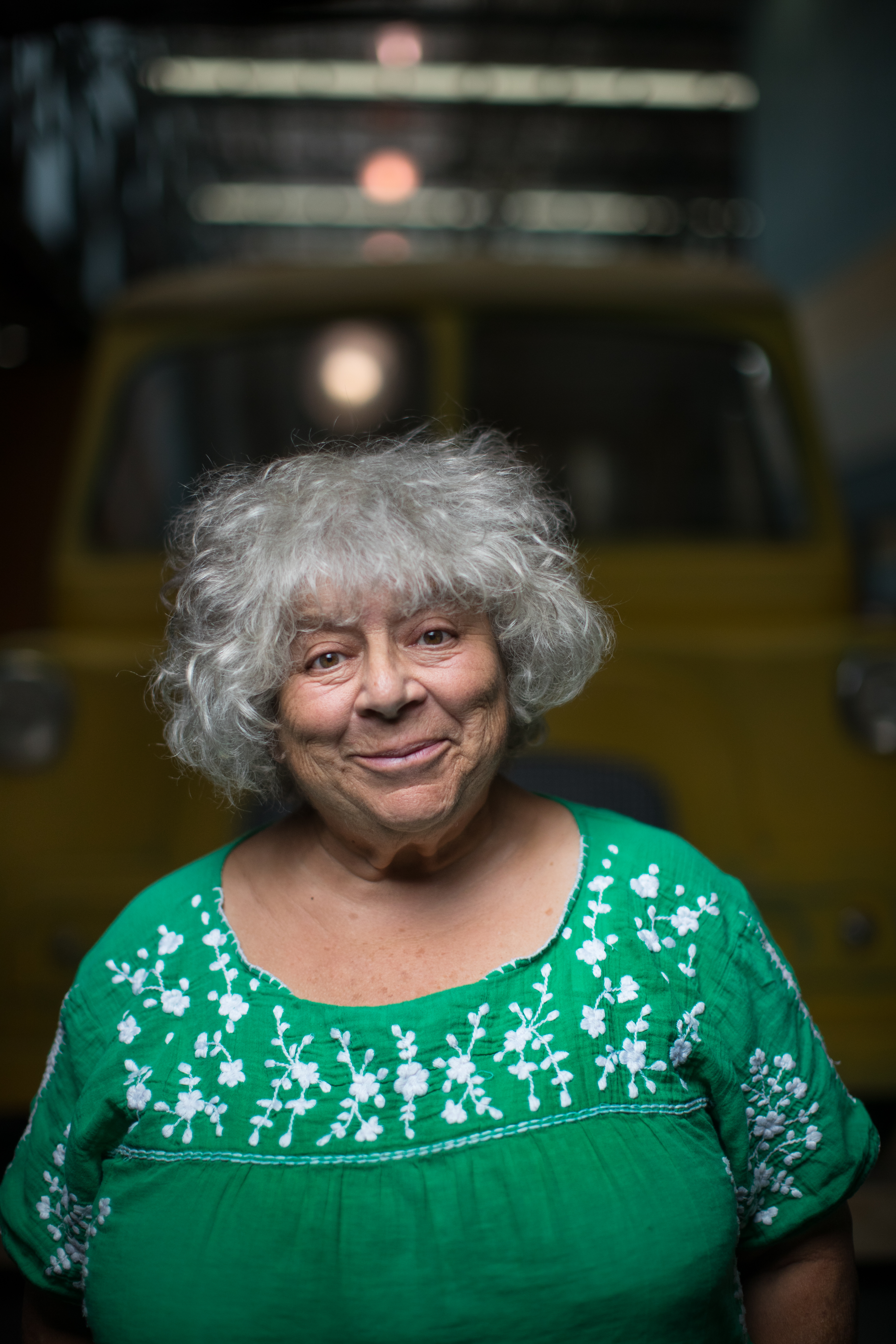 Miriam Margoyles smiling at the camera in a green floral top