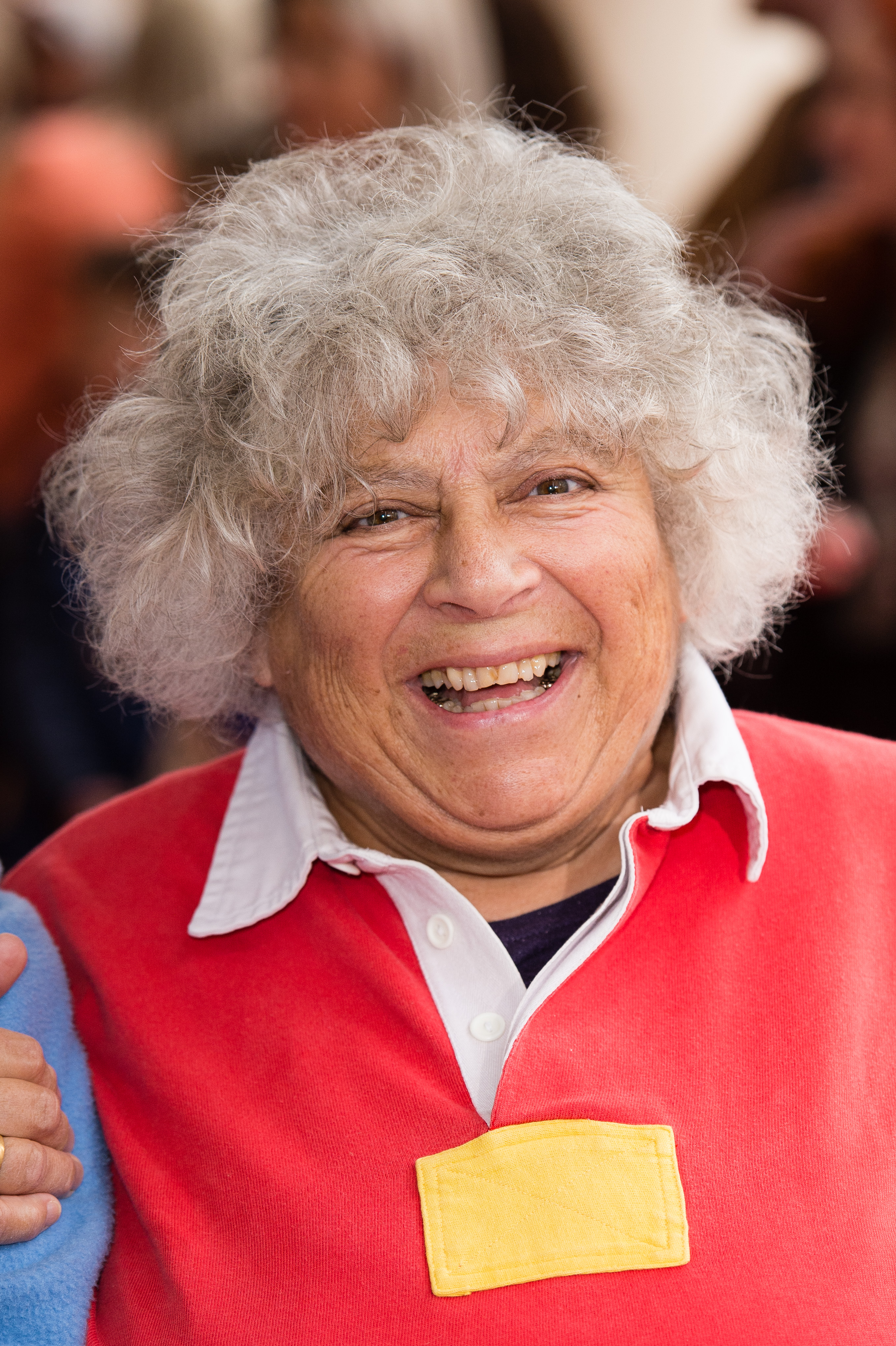 Miriam Margoyles smiling wearing a red rugby shirt