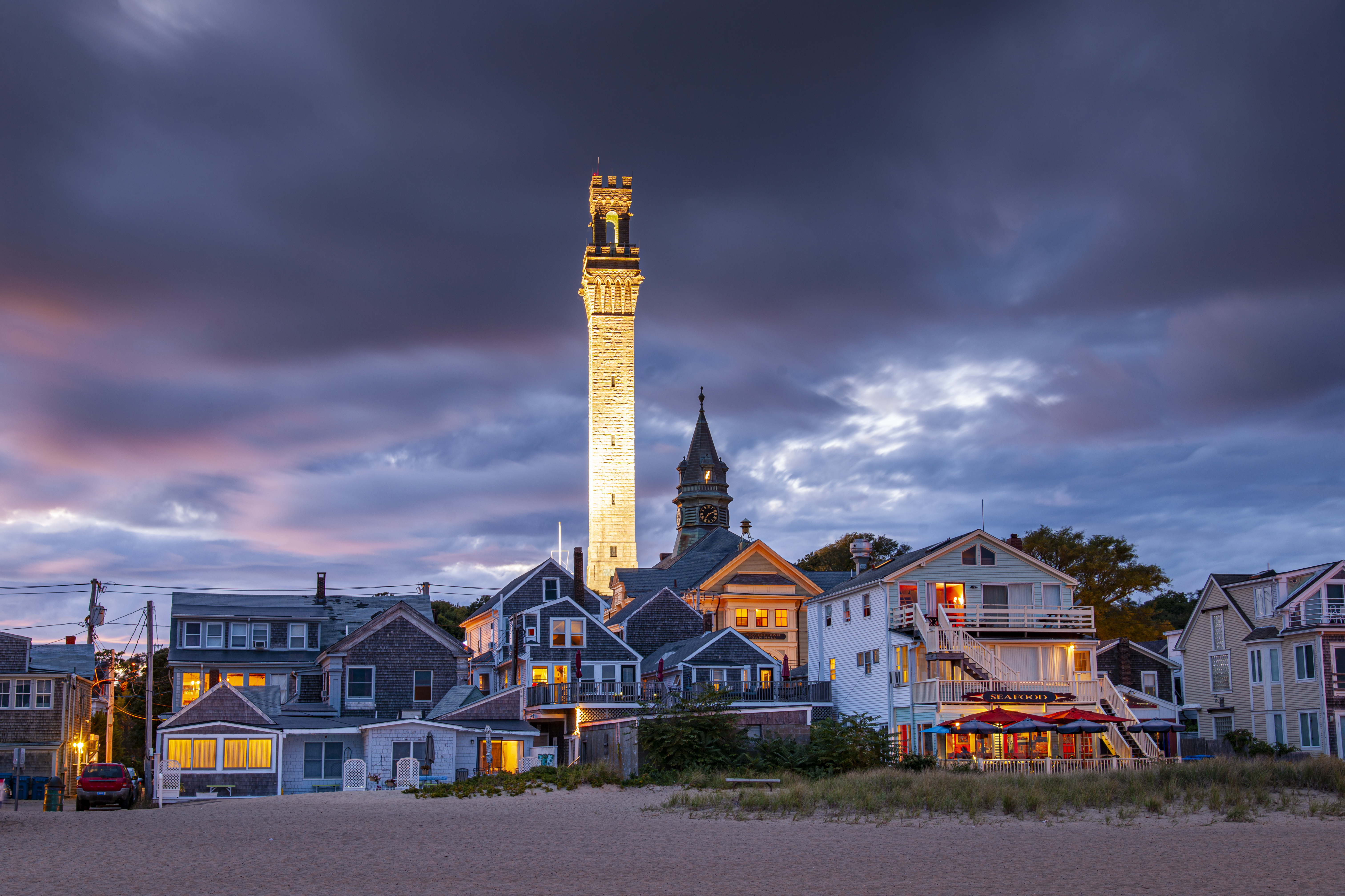 Cape Cod, Provincetown, view of the city from the seaside with Pilgrim Monument at evening.