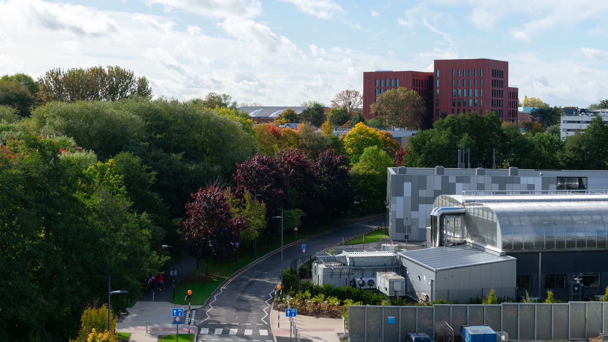 Coventry, United Kingdom – October 15, 2022: A scenic view of a road leading to University of Warwick surrounded by autumn trees, UK