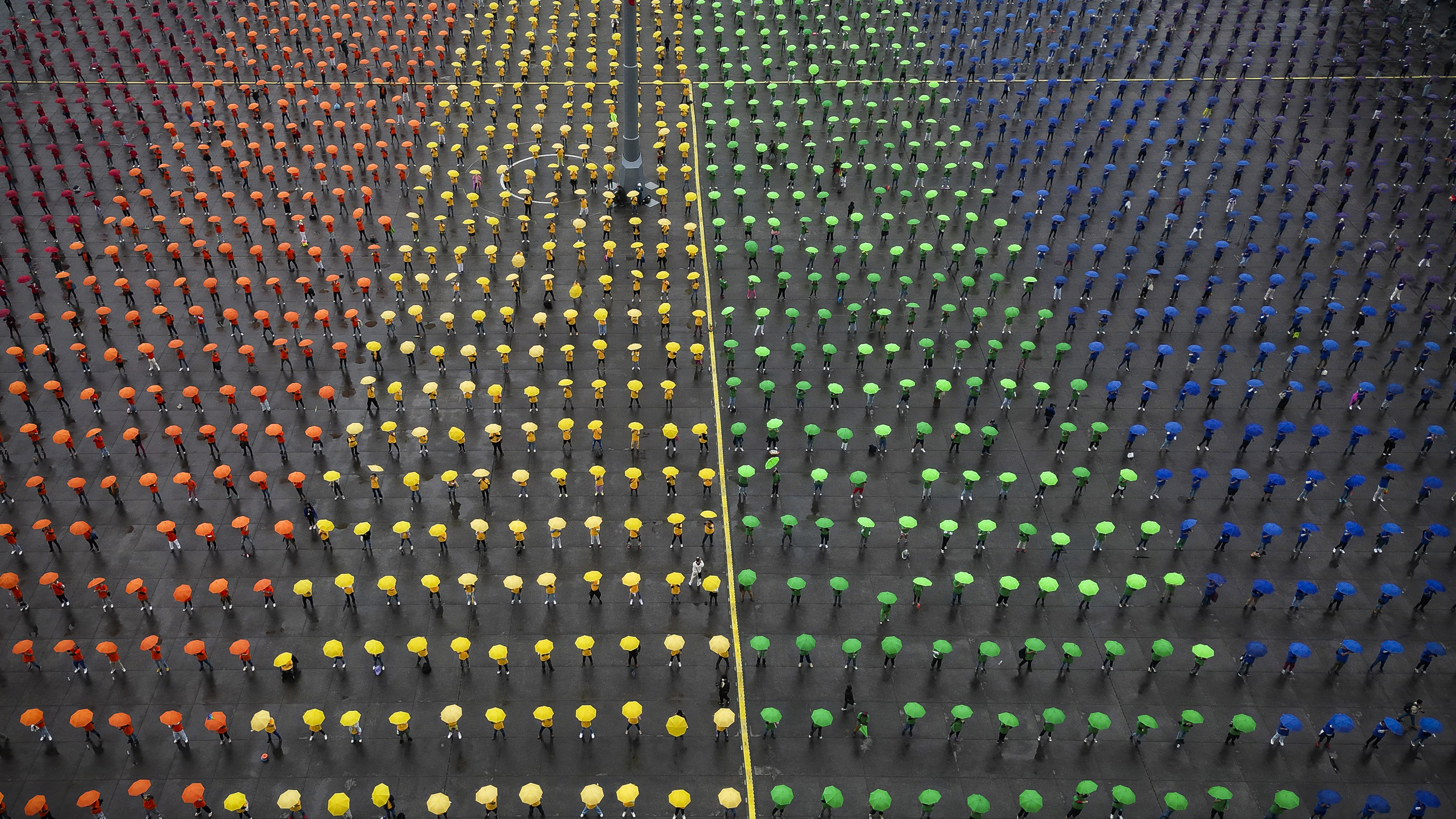 This aerial view shows people taking part in the formation of the world