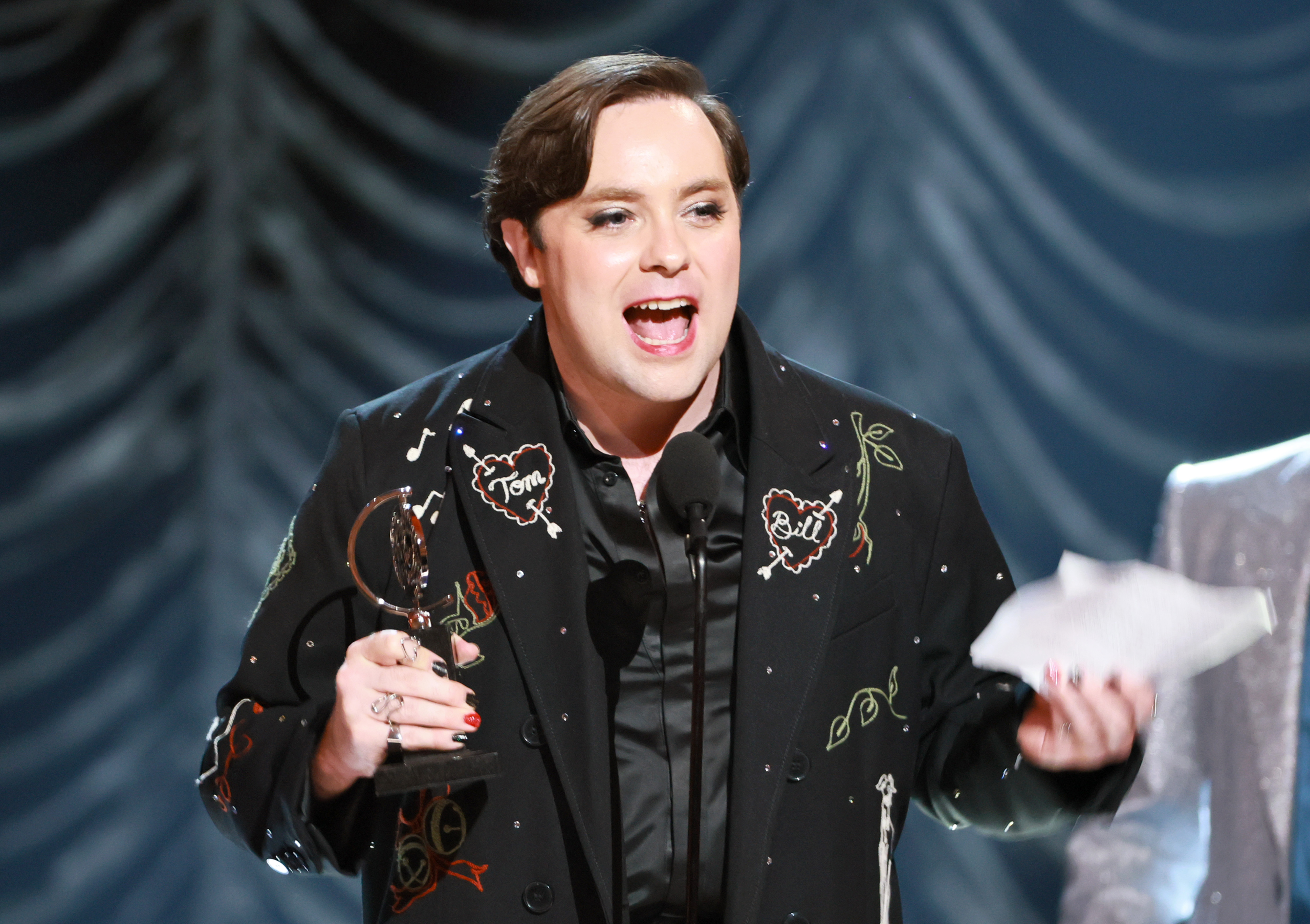 Jak Malone accepts his Tony on stage, award and speech in hand.