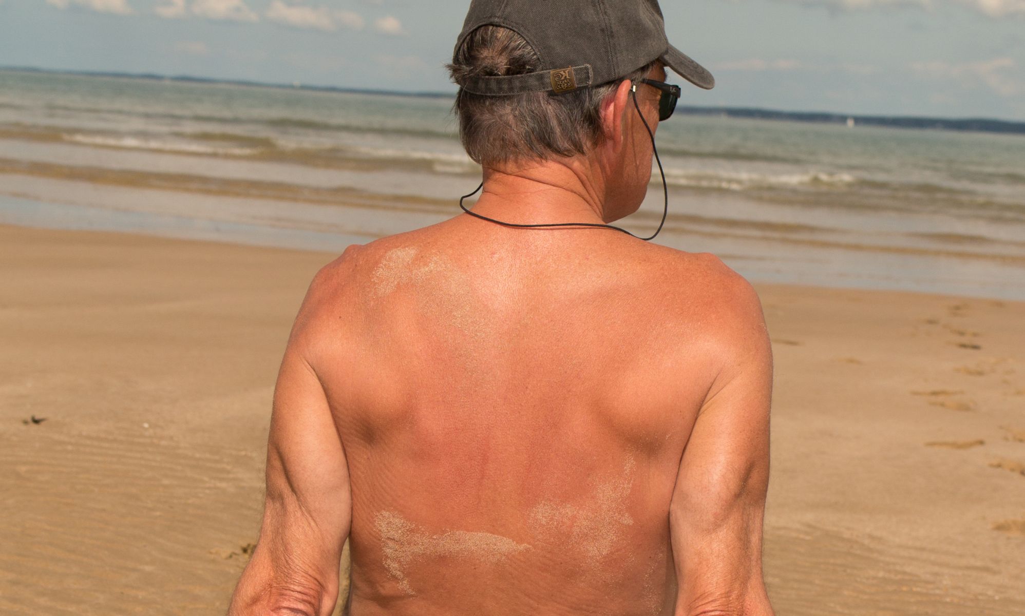 A naked man on a nudist beach.