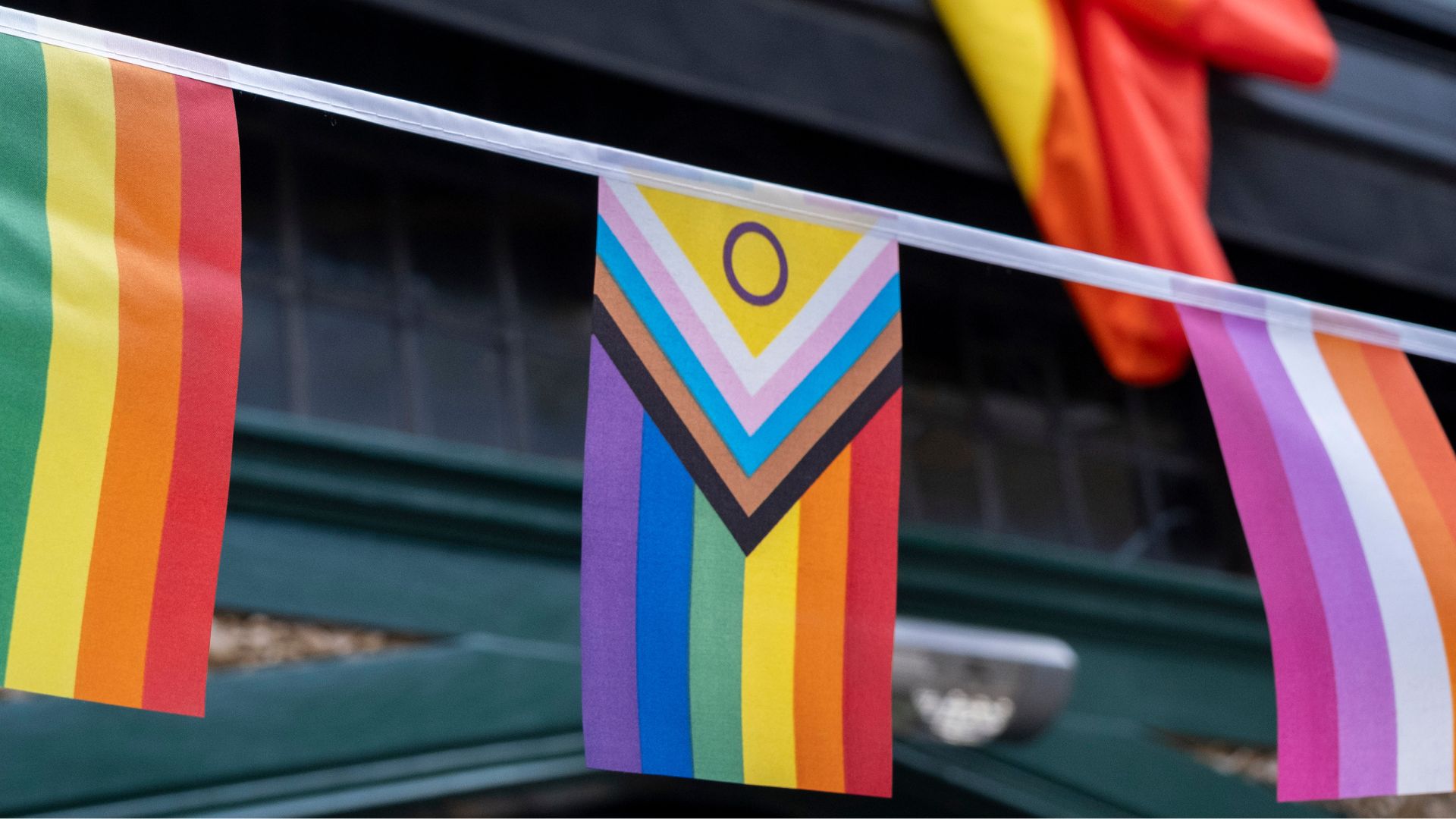 The Progress Pride flag contains symbols representing gay, trans, and intersex communities, as well as queer people of colour