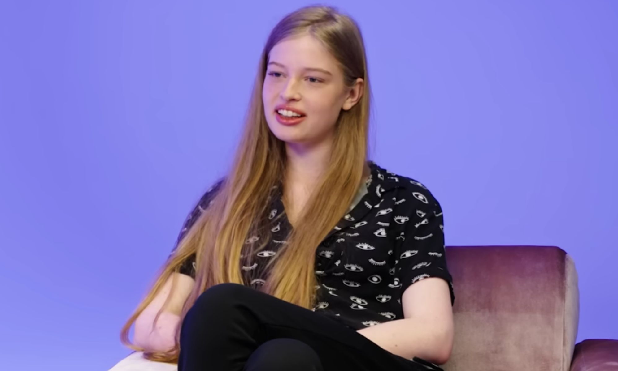 Vivian Jenna Wilson in a studio sat on a sofa.