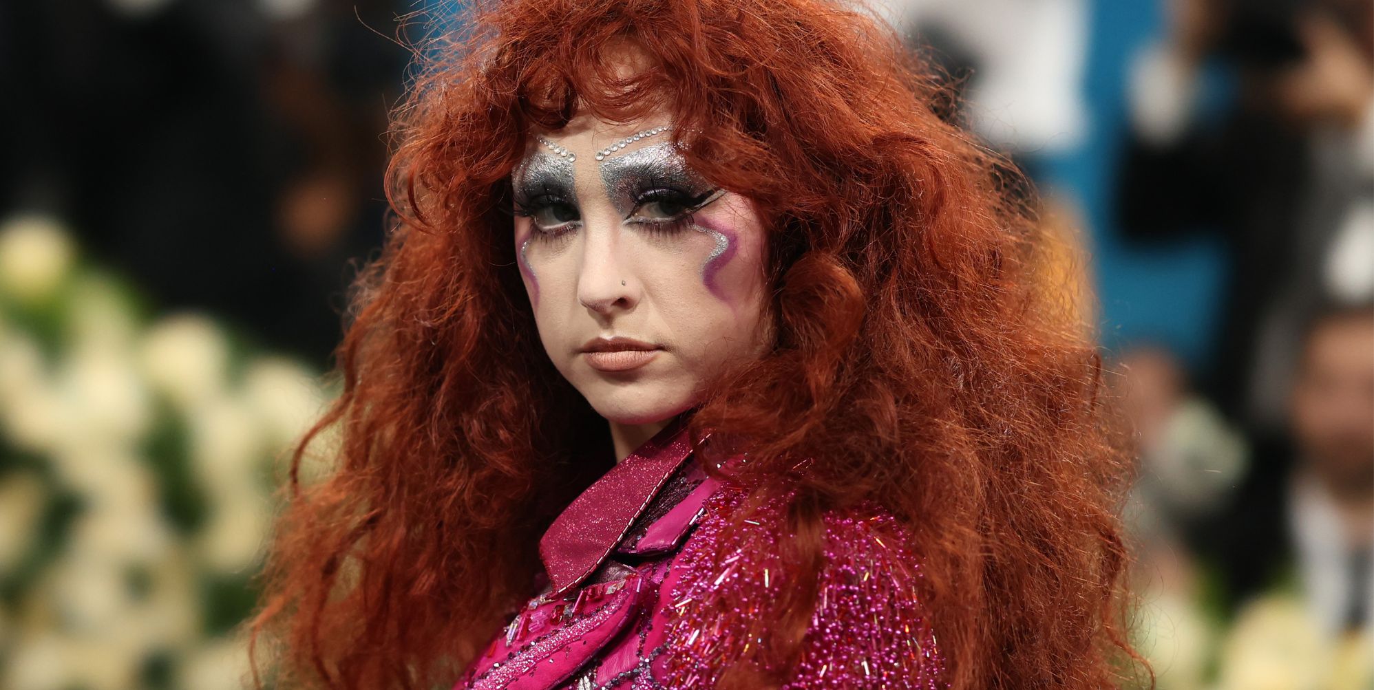 Chappell Roan poses at the 2025 Met Gala, wearing colourful make-up and a glittery pink top.