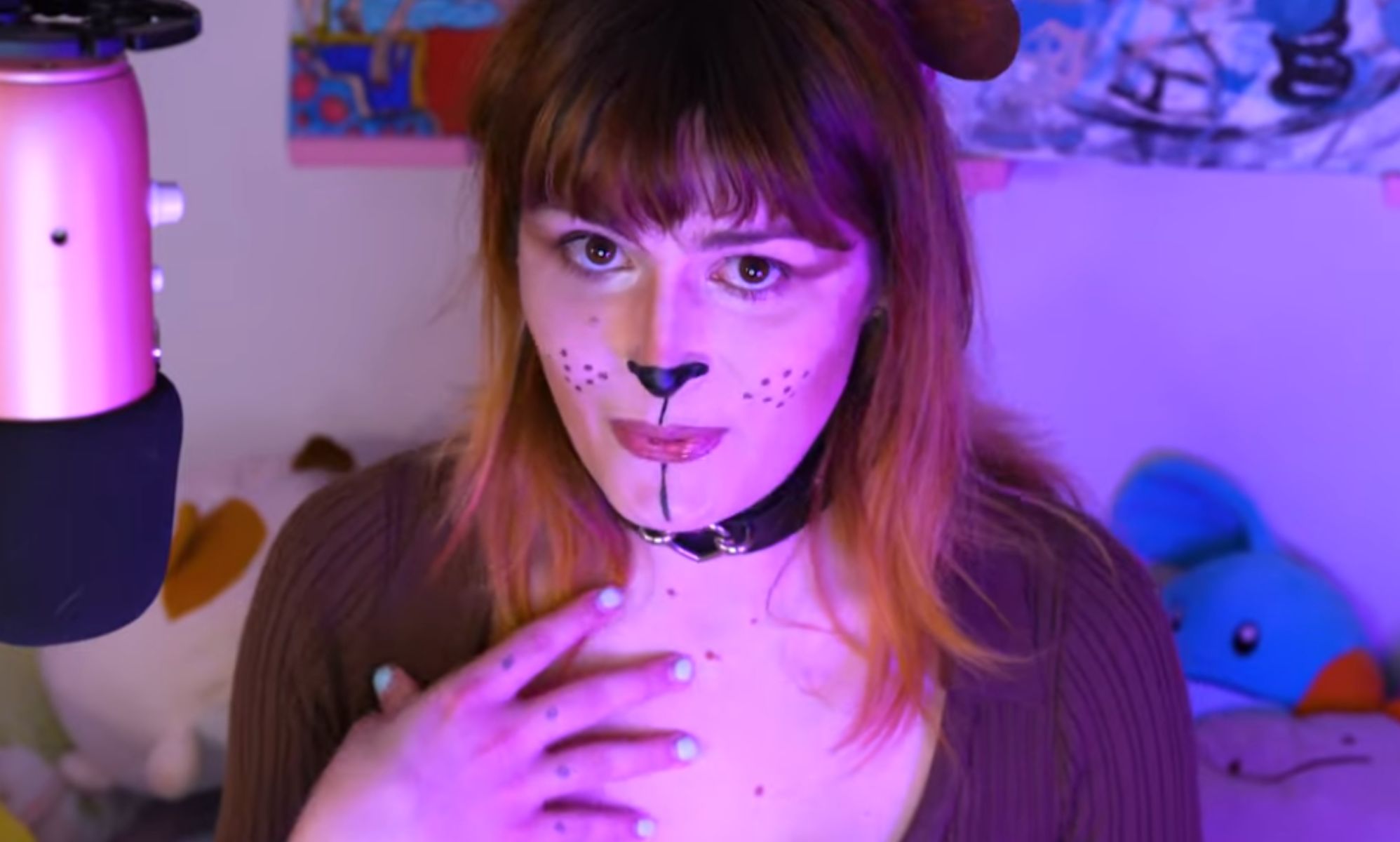 A woman in a bear-inspired outfit speaking into a microphone.