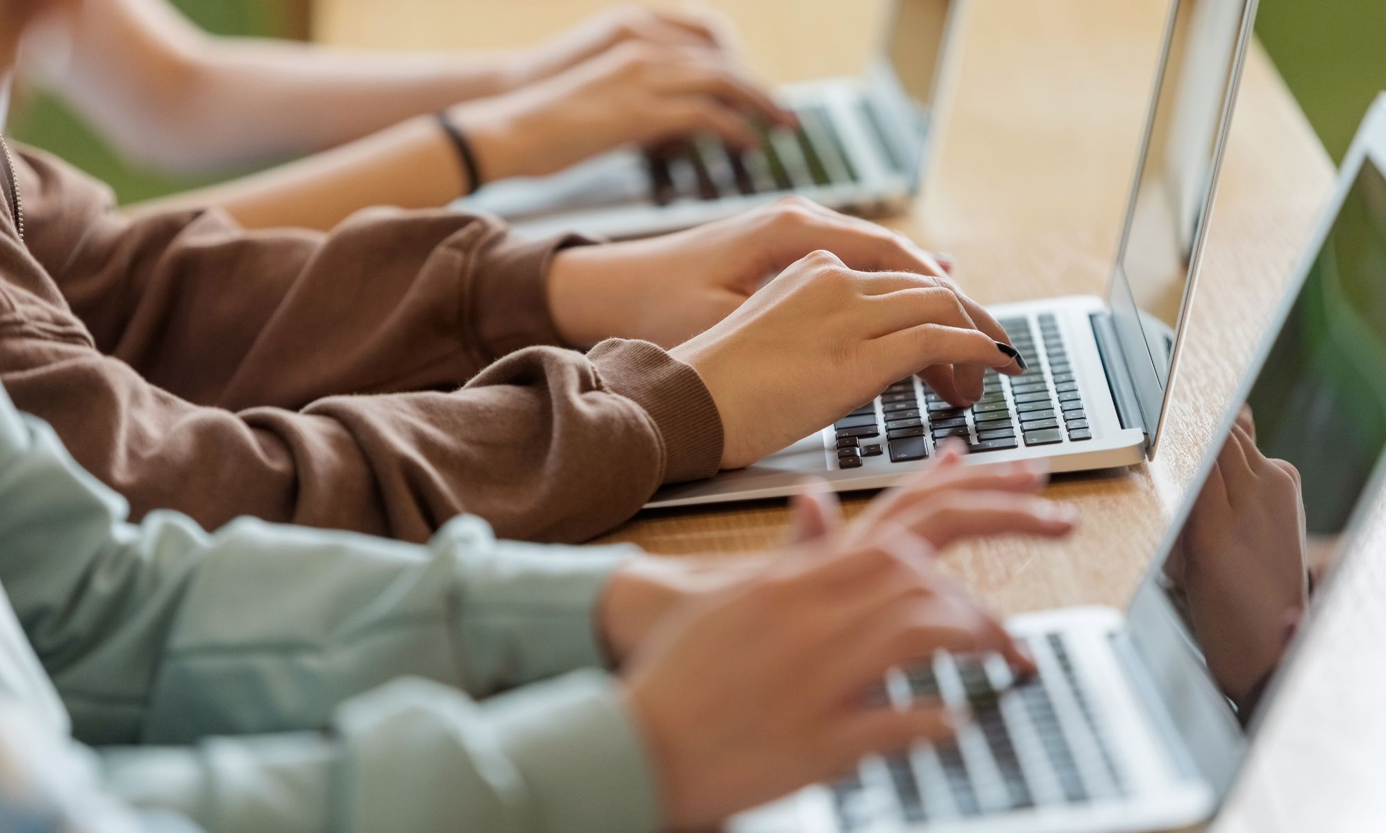 A set of children on laptops.