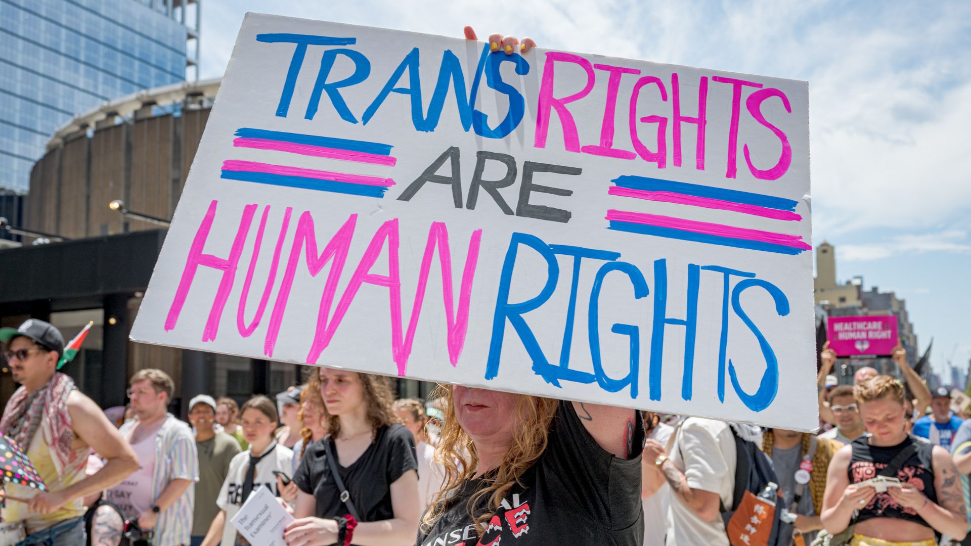 Protester holds up a sign that reads &quot;trans rights are human rights&quot;