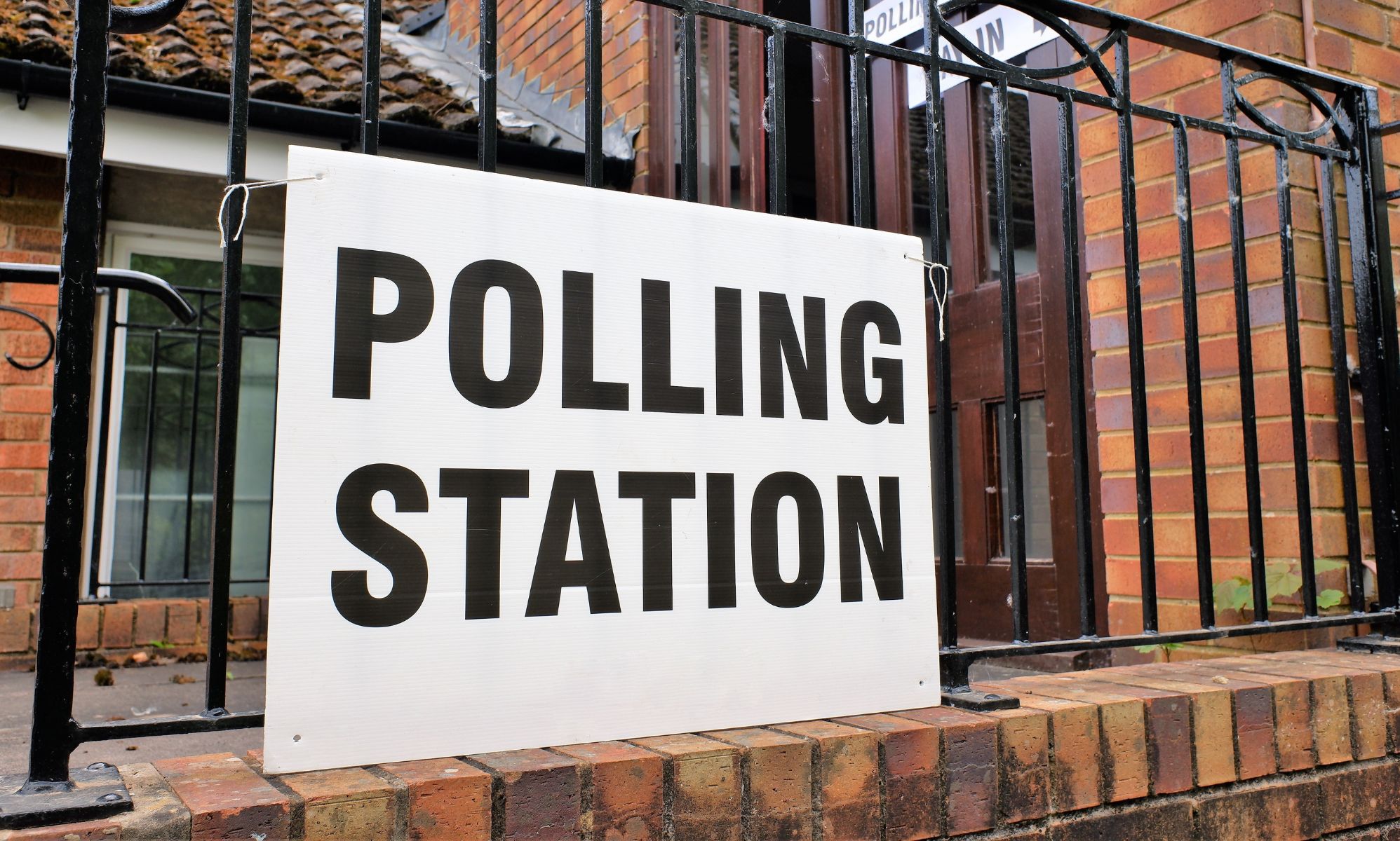 A polling station sign outside of a UK building.