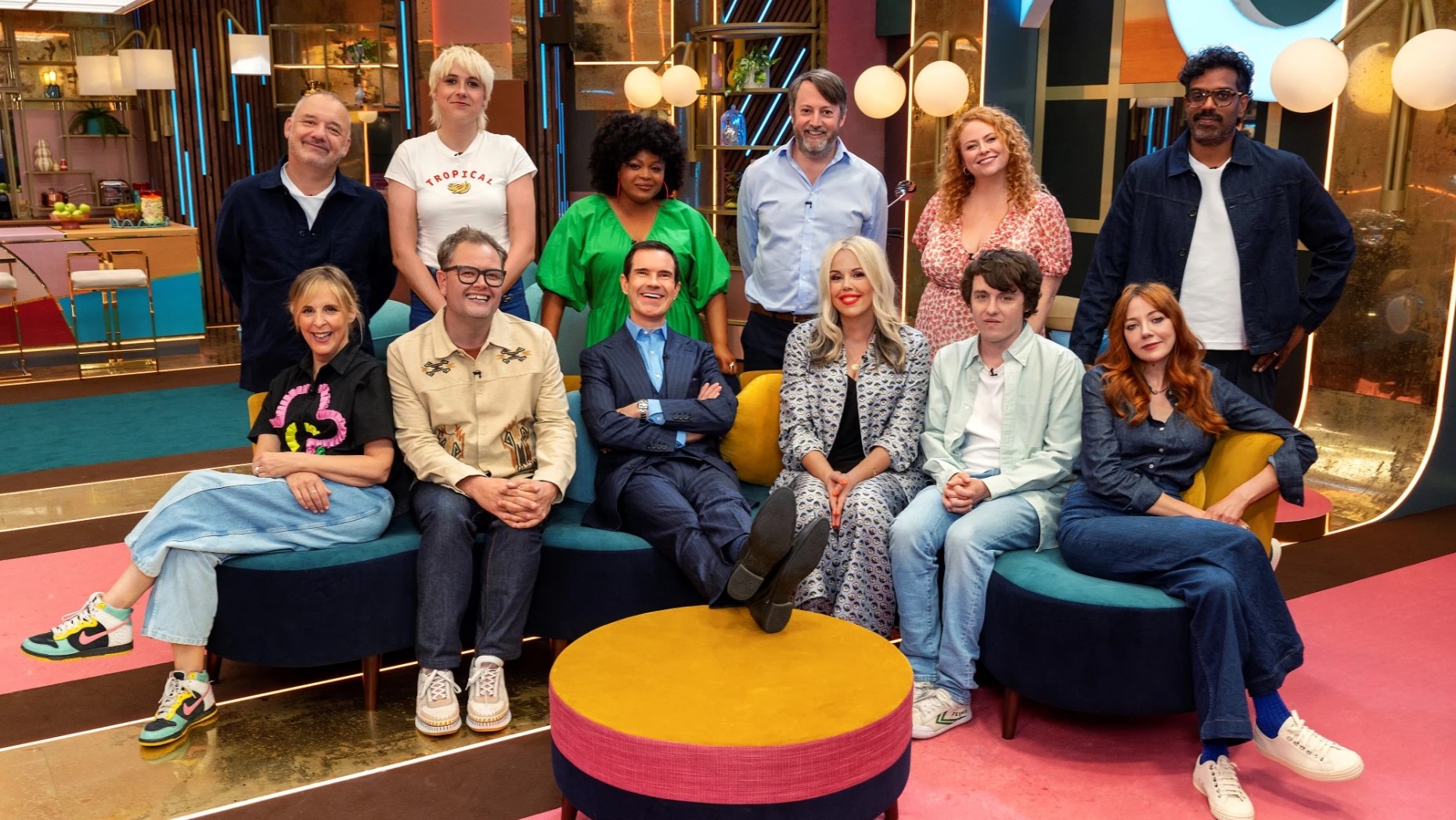 Last One Laughing UK stood and sat for promo photo. Top L to R: Bob Mortimer, Maisie Adam, Gbsemisola Ikumelo, David Mitchell, Amy Gledhill, Romesh Ranganathan Bottom L to R: Mel Giedroyc, Alan Carr, Jimmy Carr, Roisin Conaty, Sam Campbell and Diane Morgan.