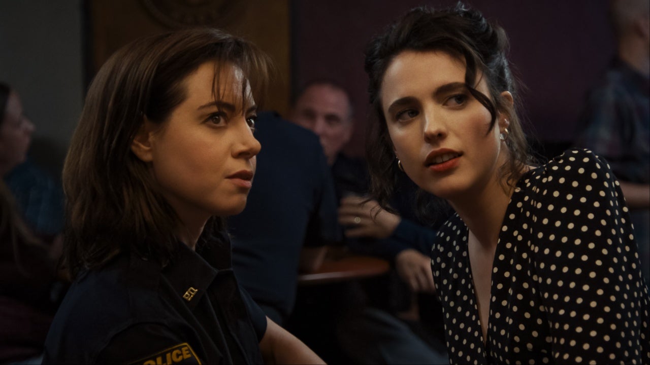Aubrey Plaza and Margaret Qualley in Honey, Don’t. Plaza is in a police uniform and Qualley is in a polka dot black and white dress.