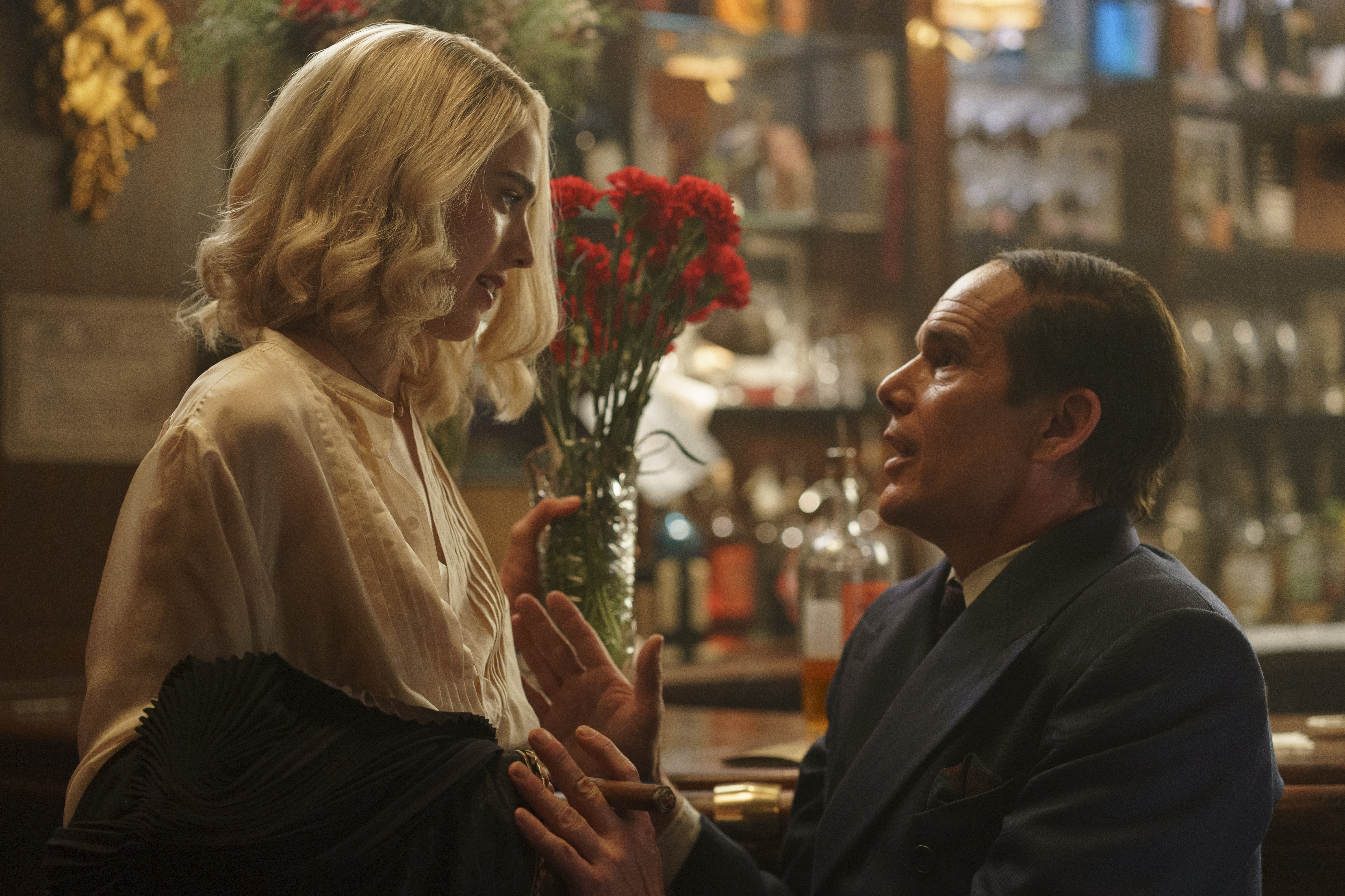 Blue Moon still: Margaret Qualley standing over Ethan Hawke at a bar.