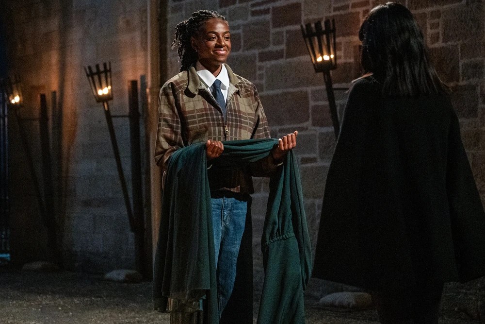 Cat Burns on The Celebrity Traitors receiving her dark green Traitors cloak