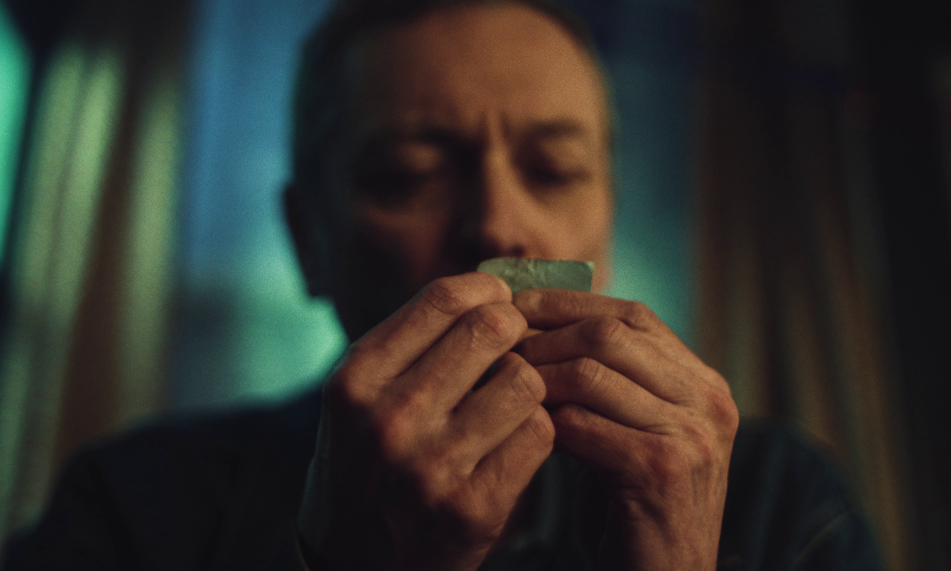 Michael Hodgson as the father, Rich, smealling his meat raffle ticket.