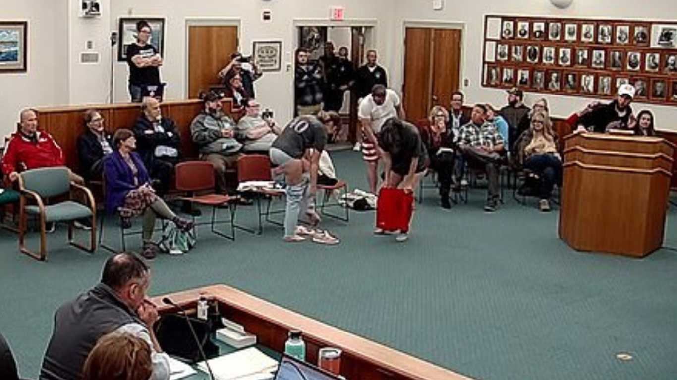 Anti-trans activists strip off at a school board meeting – but their protest is a flop