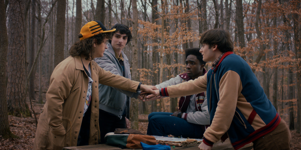 Gaten Matarazzo, Finn Wolfhard, Caleb McLaughlinand Noah Schnapp with their hands in.