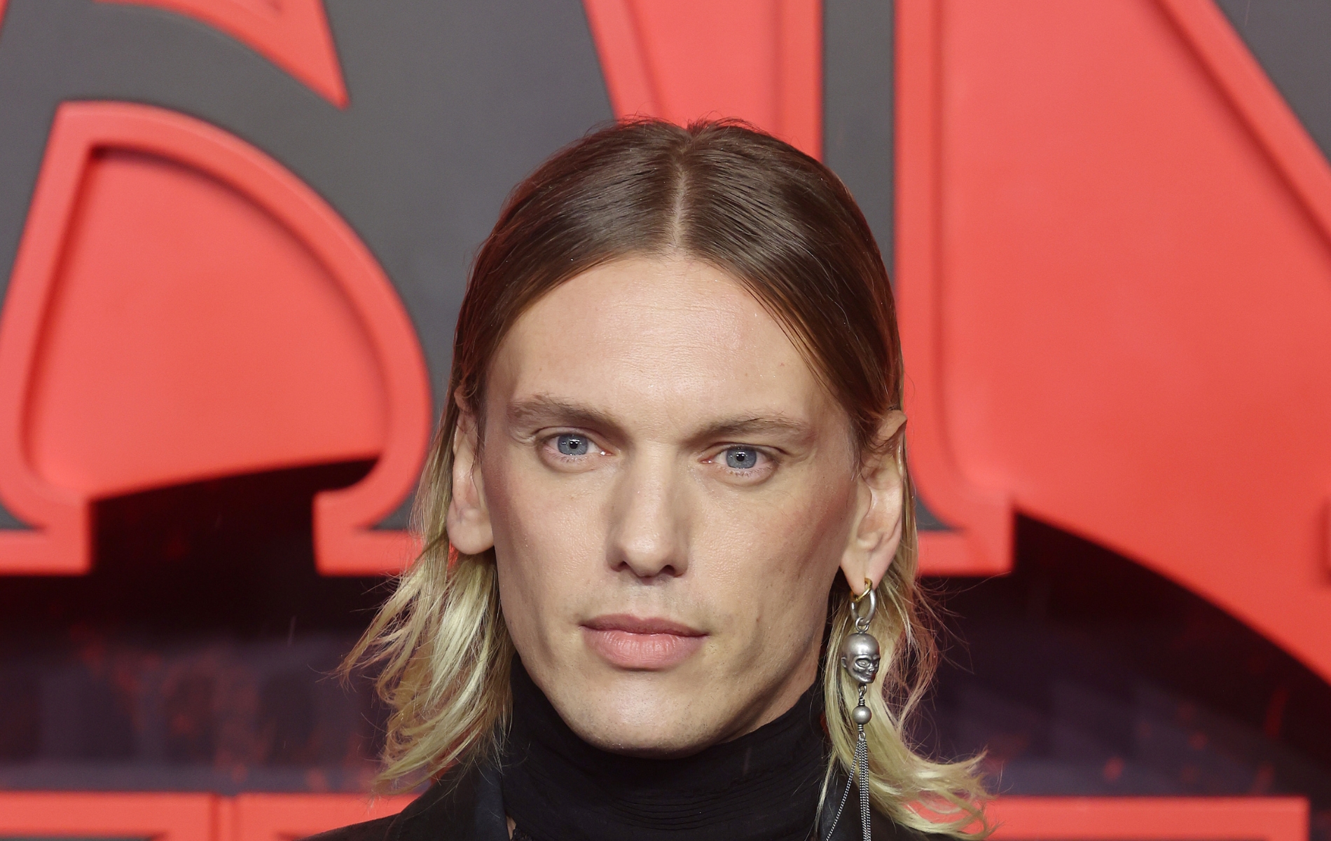 Jamie Campbell Bower thrills fans with skirt-and-pearls combo at Stranger Things premiere