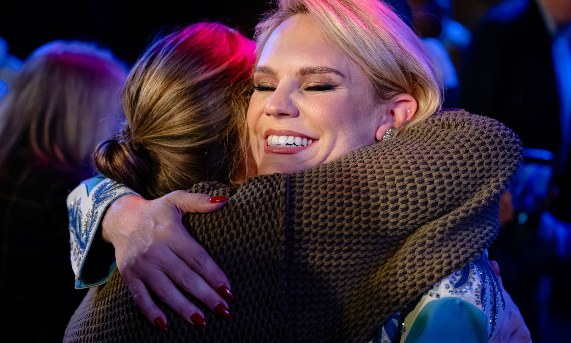 Aftyn Behn hugging someone.