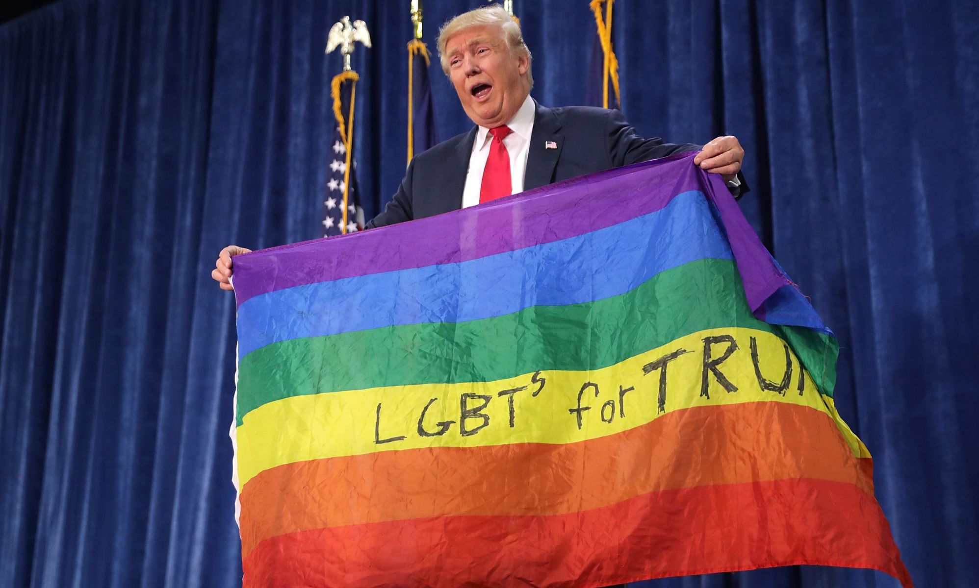 Donald Trump infamously holding the &quot;LGBTS for Trump&quot; flag during his first electoral campaign in 2016. 