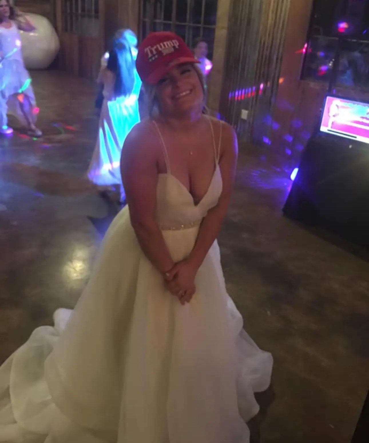 Madison Paige Jones wearing a red MAGA hat and a wedding dress.