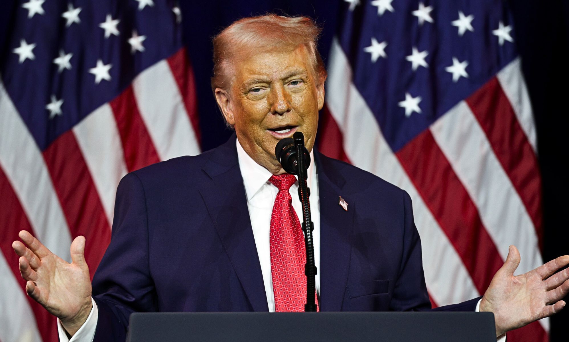 US president Donald Trump speaking at a podium.