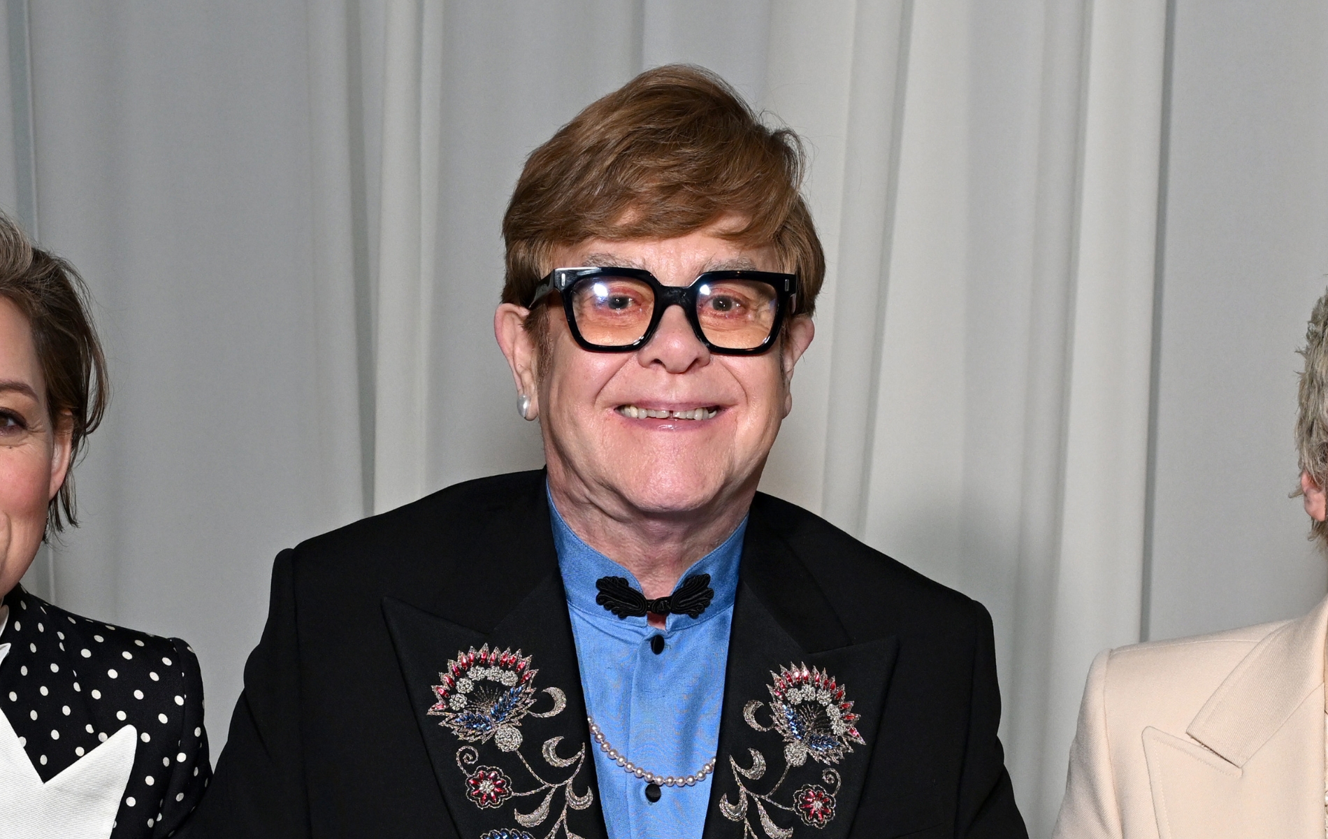 Elton John has turned a big chunk of his knee into a statement necklace
