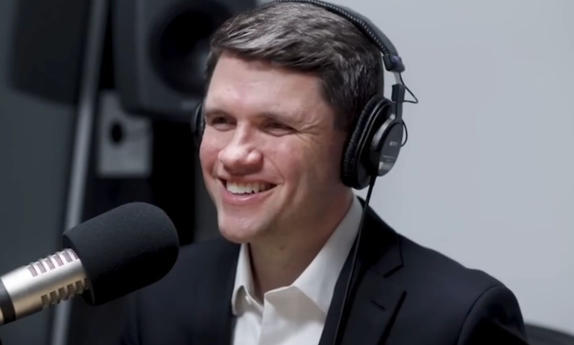 James Talarico, pictured in a recording booth with headphones on.