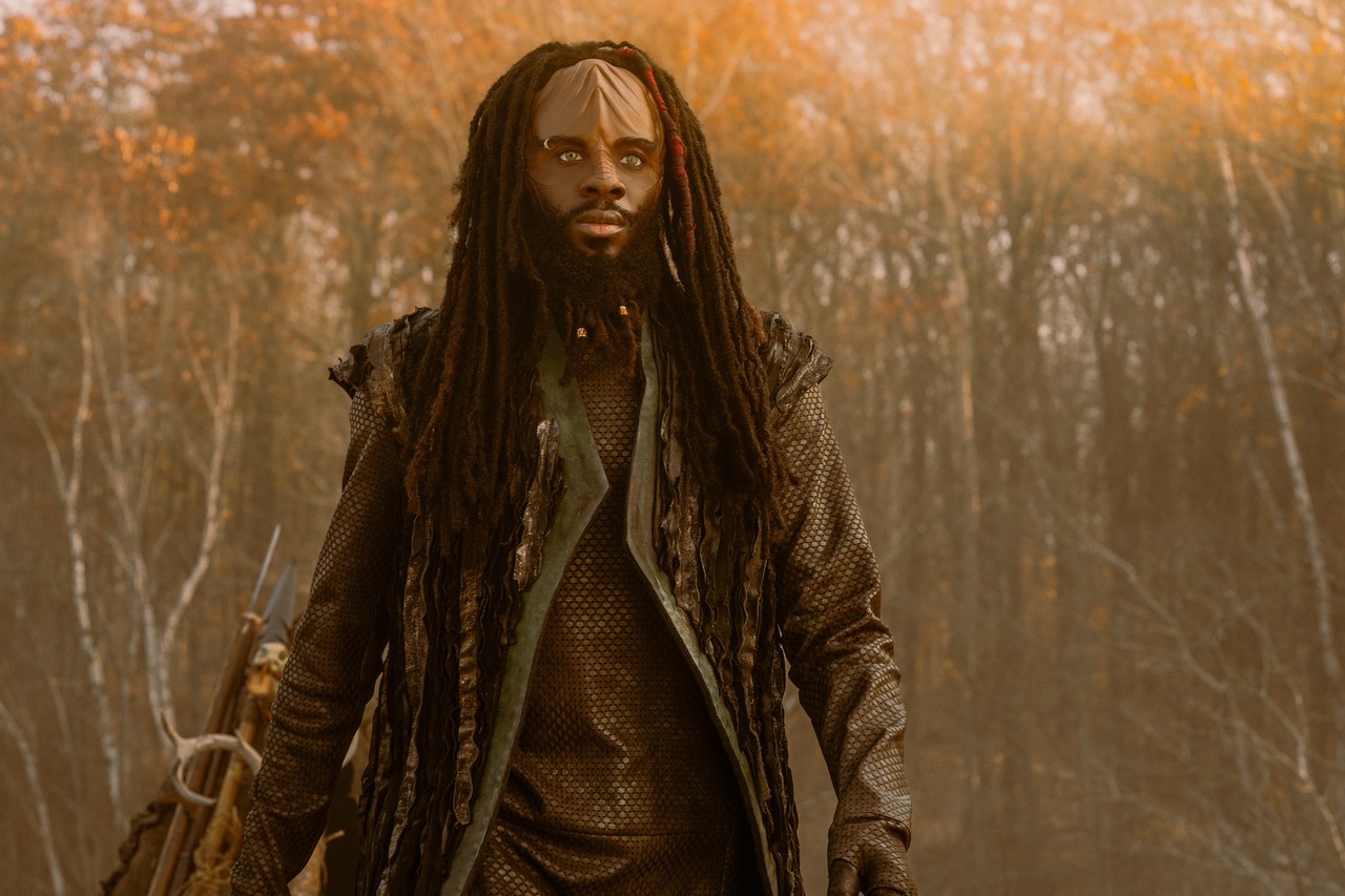 Actor Karim Diané as Jay-Den Kraag in Star Trek: Starfleet Academy. He has long dark brown dreadlocks and a camo mesh coat